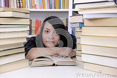 Student with books in a library Stock Photo