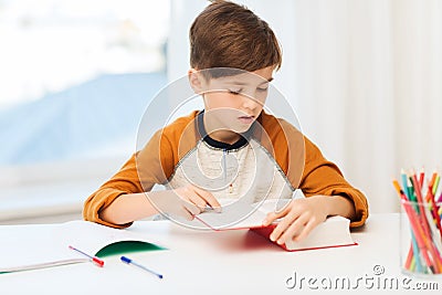 Student boy reading book or textbook at home Stock Photo