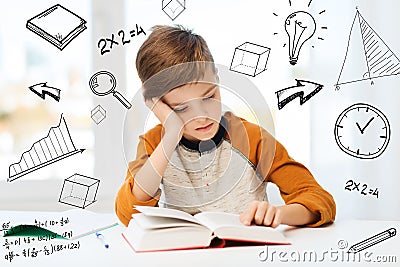 Student boy reading book or textbook at home Stock Photo