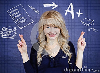 Student crossing her fingers, hoping for best, good grades in school Stock Photo