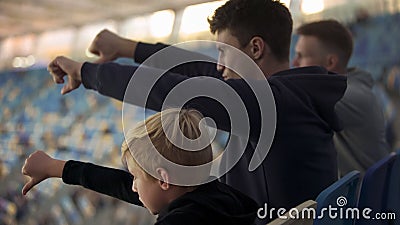 Student fans and little boy booing sport game at stadium, watching junior match Stock Photo