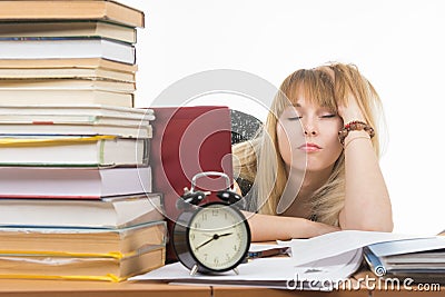 Student fell asleep leaning his head on his hand, late at night in preparation for the exam Stock Photo
