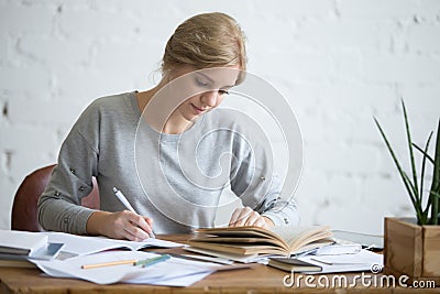 Student female performing a written task in a copybook Stock Photo