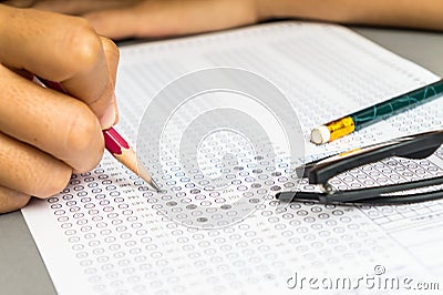 Student filling answers , drawing selected choice on answer sheets Stock Photo