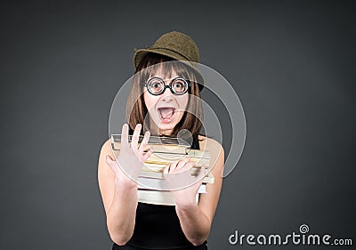 Student in funny glasses with books on grey. Nerd girl studying. Education. Stock Photo