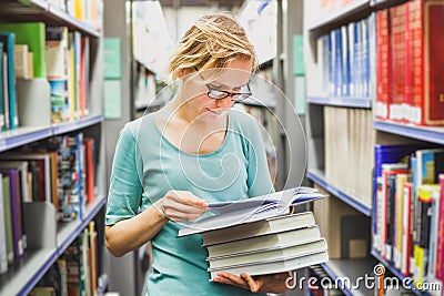 Student girl in the library reading books, education Stock Photo