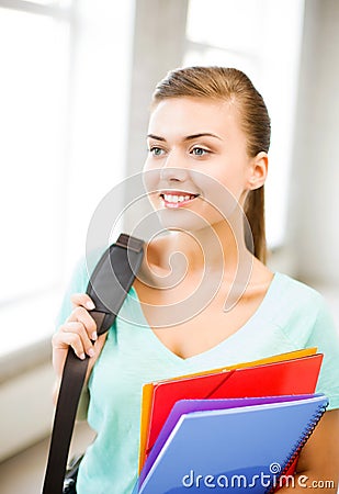 Student girl with school bag and color folders Stock Photo