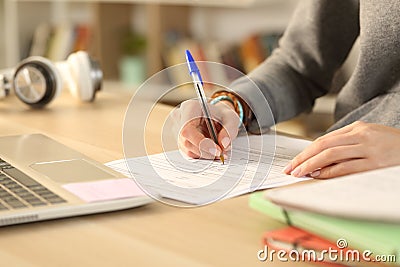 Student hands filling out form document at home Stock Photo