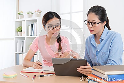 Student with her home teacher using mobile digital Stock Photo