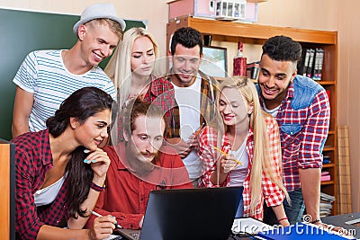 Student High School Group With Professor Using Laptop Computer Sitting At Desk, Young People Teacher Discuss Stock Photo