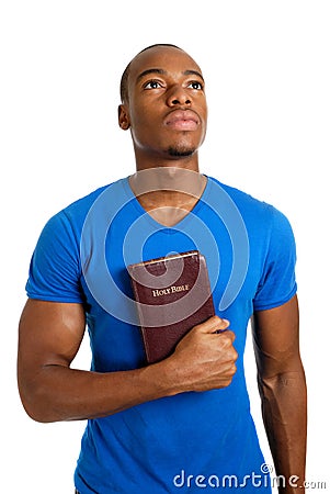 Student holding a bible looking up Stock Photo