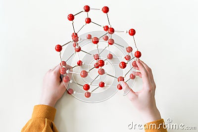 Student holding molecular structure model. Science class. Personal perspective view. Stock Photo