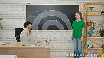 Student and Instructor Discuss Python Code in Modern Classroom Stock Photo