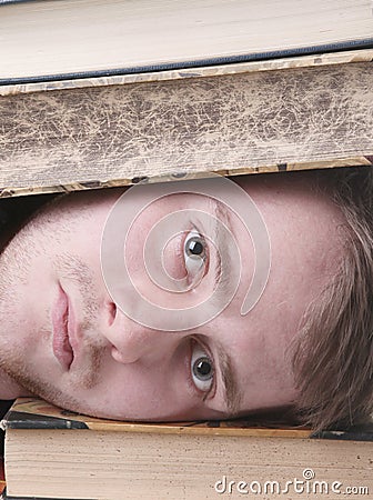 Student inundated with study and books Stock Photo