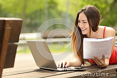 Student learning with a laptop in an university campus Stock Photo