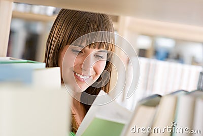 Student in library - cheerful woman read book Stock Photo