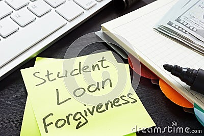 Student loan forgiveness written on a memo stick. Stock Photo