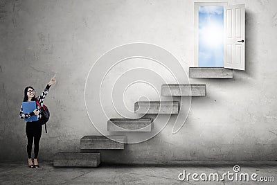 Student pointing at opportunity door Stock Photo