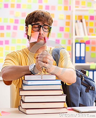 Student preparing for exams with many conflicting priorities Stock Photo
