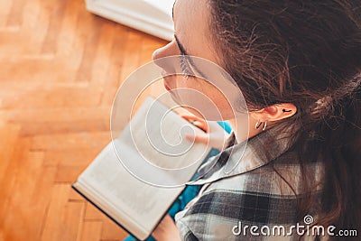 A student reads a book. View from the top, over the head. Concept of reading and learning Stock Photo