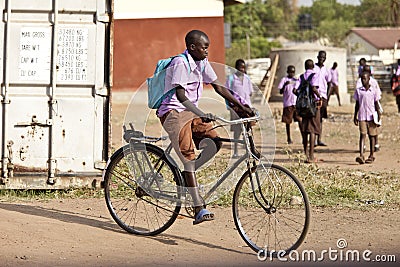 Student riding bicycle in Africa Editorial Stock Photo