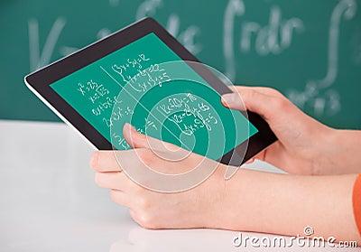 Student solving math's problem on digital tablet in classroom Stock Photo