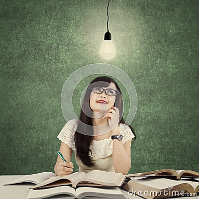 Student studying and get idea under light bulb Stock Photo