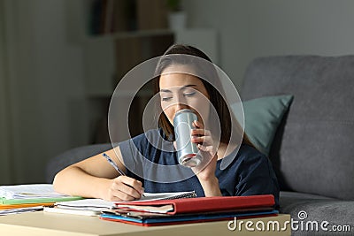 Student studying hard drinking an energy beverage Stock Photo
