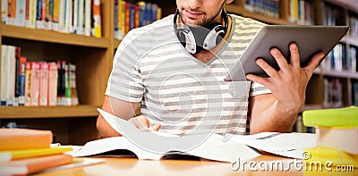 Student studying in library with tablet Stock Photo