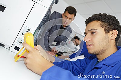 Student testing voltage industrial power distribution center Stock Photo