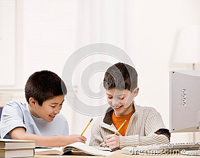 Student with text books helping friend do homework Stock Photo