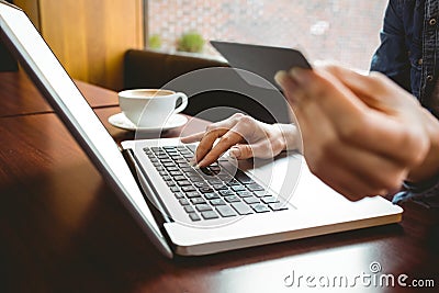 Student using laptop in cafe to shop online Stock Photo