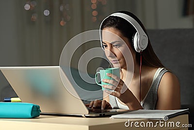 Student watching video tutorials in the night Stock Photo