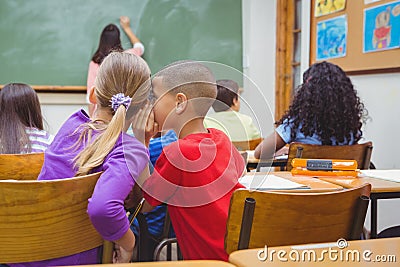 Student whispering into another students ear Stock Photo