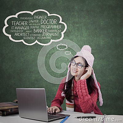 Student with winter clothes think her dream jobs Stock Photo