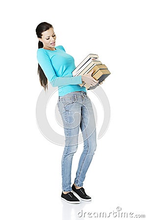 Student woman holding heavy books Stock Photo