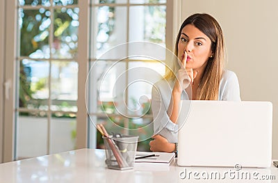 Young beautiful student woman with laptop at table, at home Stock Photo