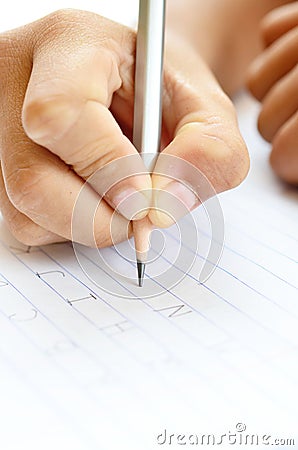 Student writing alphabet Stock Photo