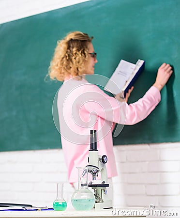 Student writing chalkboard defocused. Biology concept. Biology laboratory. Microbiology and bioengineering. Microscope Stock Photo