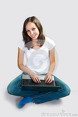 Student young girl with laptop computer on gray background Stock Photo