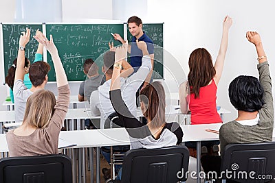 Students answering teacher in mathematics class Stock Photo