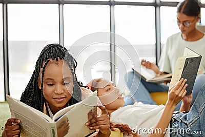 Students, books and library in college to reading, relax and learning for girl friends. Education, study and scholarship Stock Photo