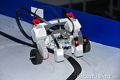 Robot car assembled from designer details rides on magnetic road by startup students Stock Photo