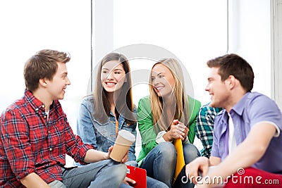 Students communicating and laughing at school Stock Photo