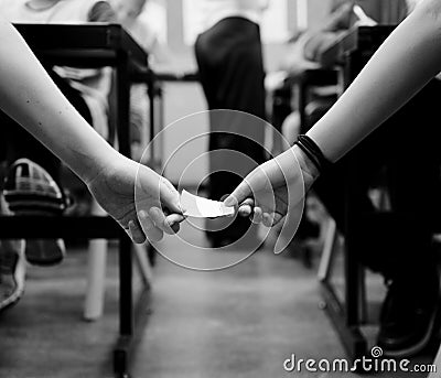 Students doing cheating exam in classroom Stock Photo