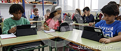 Students learning the dangers and the good uses of the internet and social networks Editorial Stock Photo