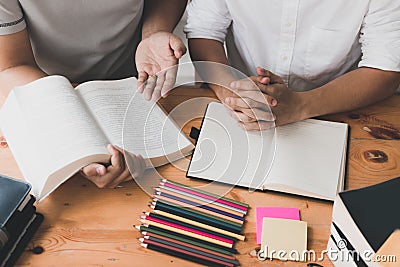 Students are explaining the information in the book to a friend. Stock Photo