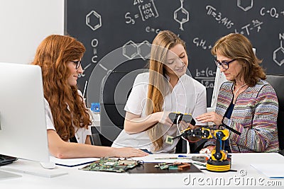 Students explaining their new project to a teacher Stock Photo