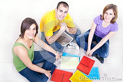 Students on the floor with notebooks Stock Photo