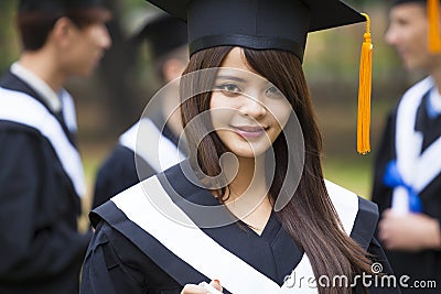 Students in graduation gowns on university campus Stock Photo
